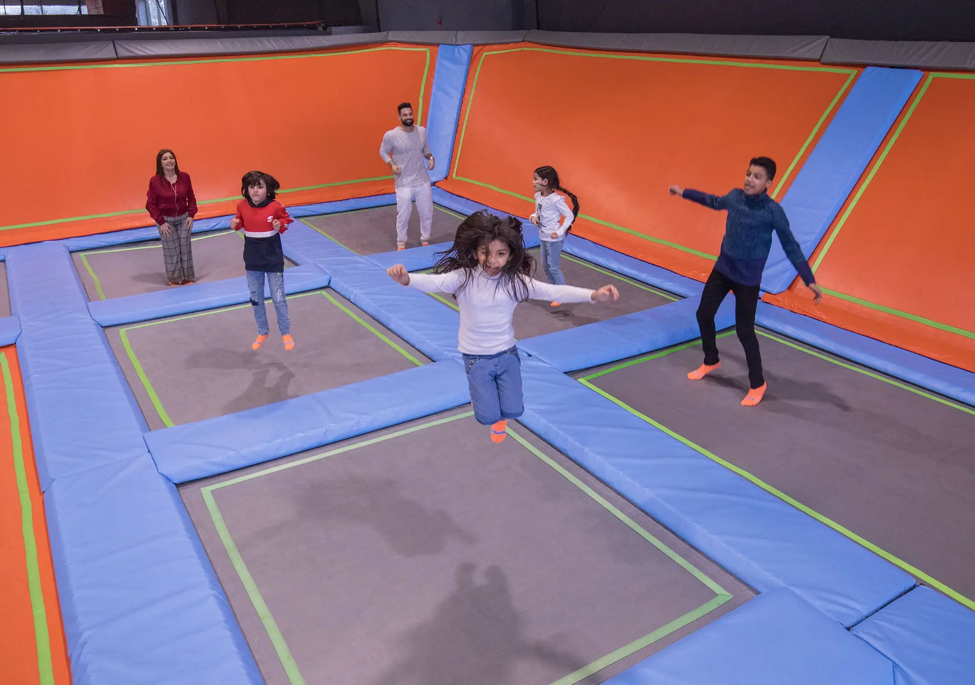 Family jumping at Trampo